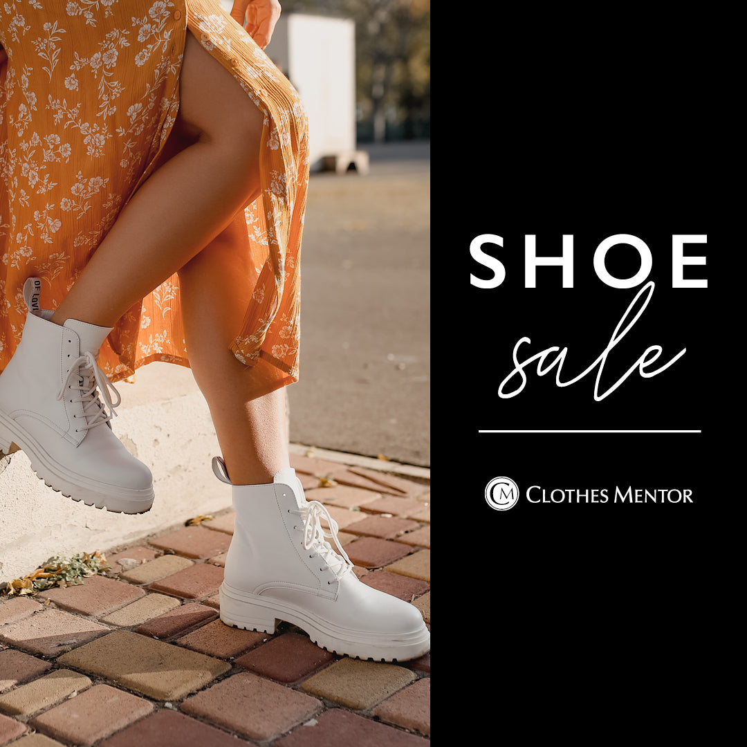 Person wearing white boots with an orange floral dress, standing on a brick pavement, with 'Shoe Sale' text and 'Clothes Mentor' logo.