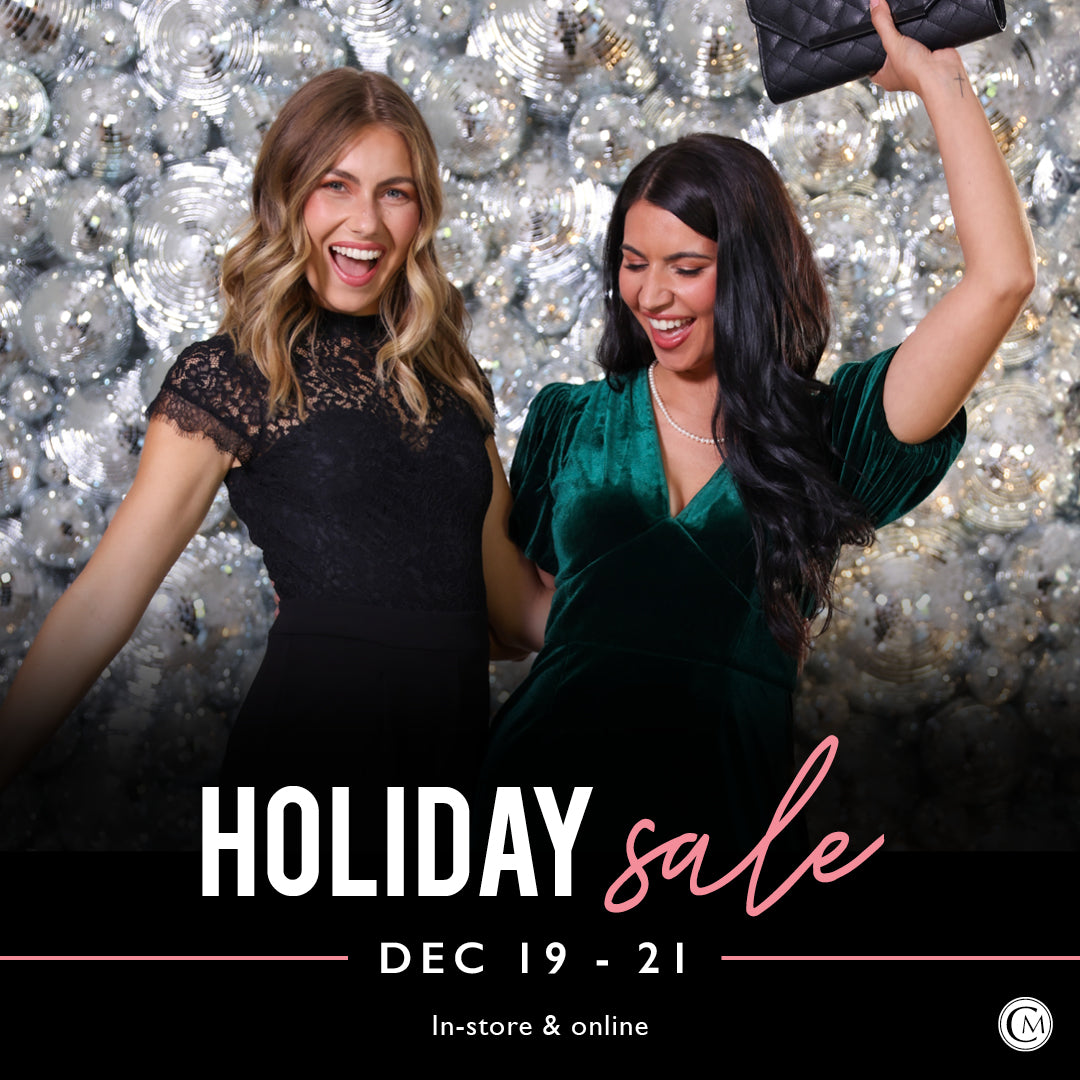 Two women in festive outfits with a 'Holiday Sale' text overlay against a sparkling background.