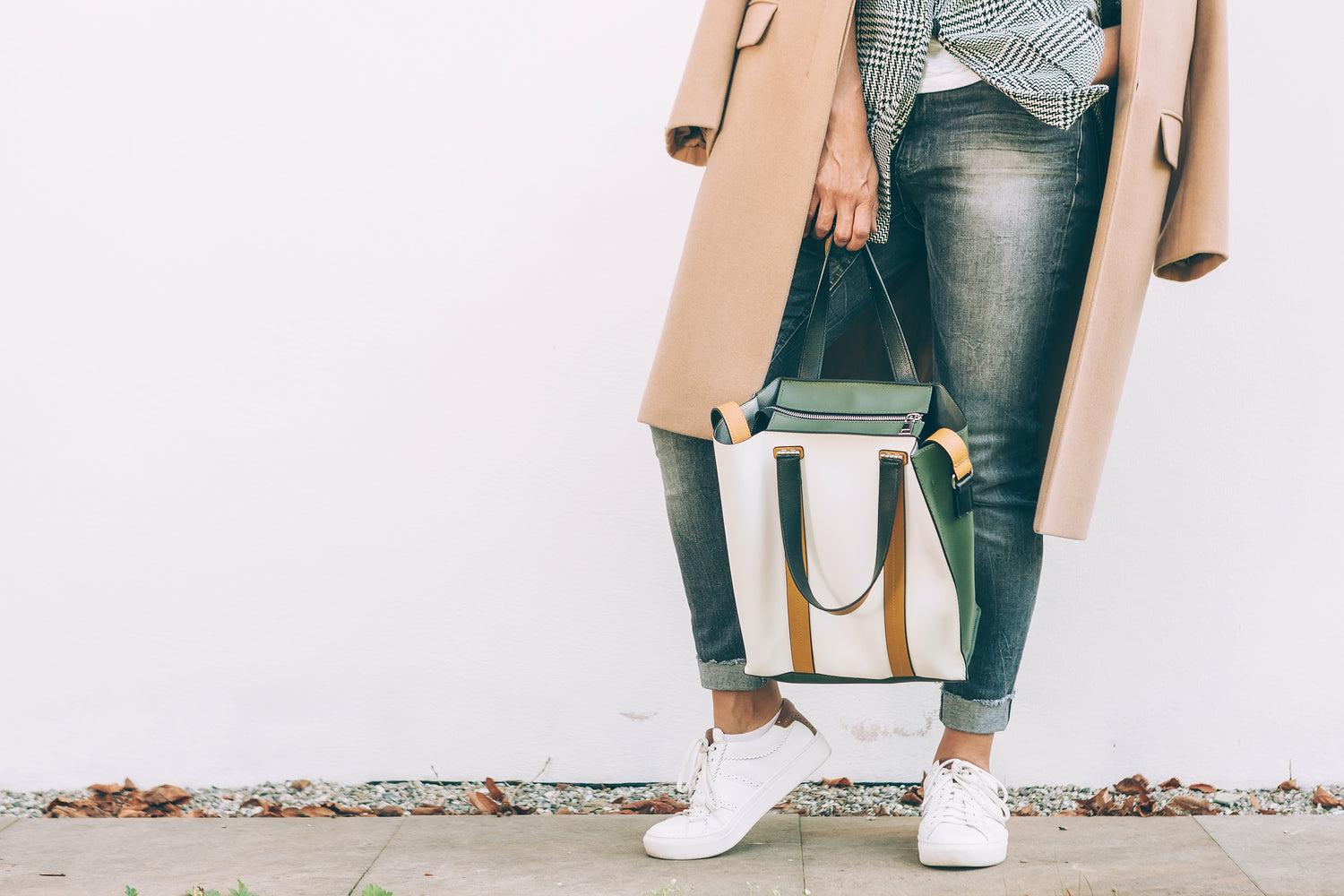 woman in jeans holding handbag